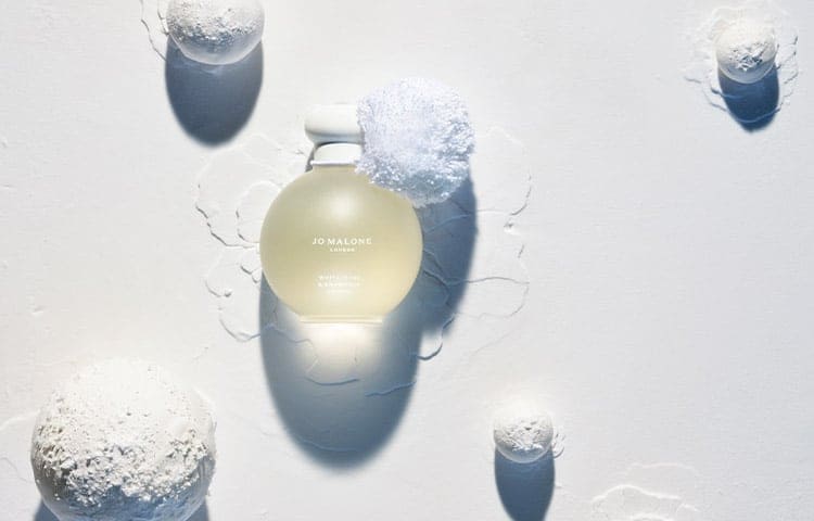 white moss & snowdrop 100ml cologne in limited edition frosted glass design and snowball shape. Surrounded by white snowballs 