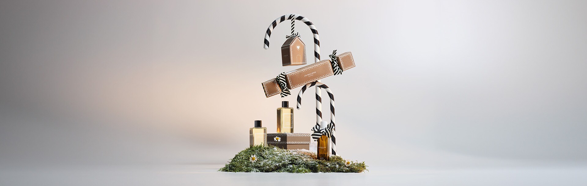 image of jo malone london boxes stacked with a miniature cologne, travel candle and travel size body cream